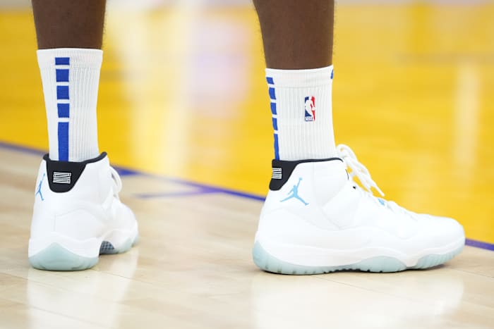 White and blue Air Jordan 11 shoes.